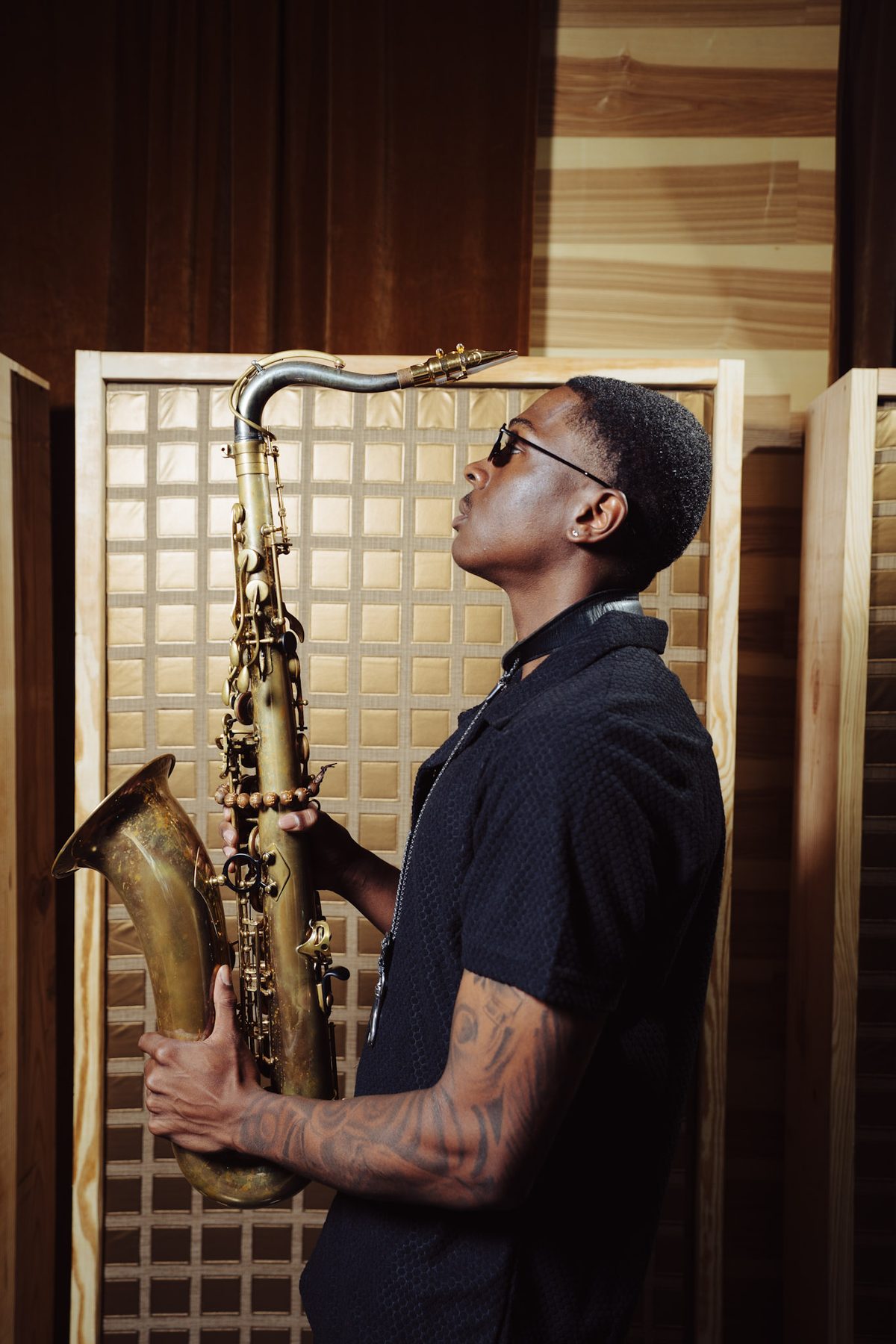 Ry Lo playing tenor saxophone in the studio